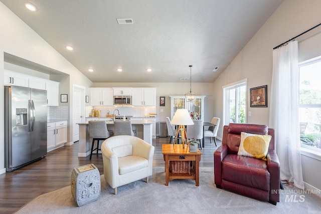 3772 S Walnut Ridge Way, Nampa, ID 83686 - living area featuring lofted ceiling, dark wood finished floors, healthy amount of natural light, and recessed lighting