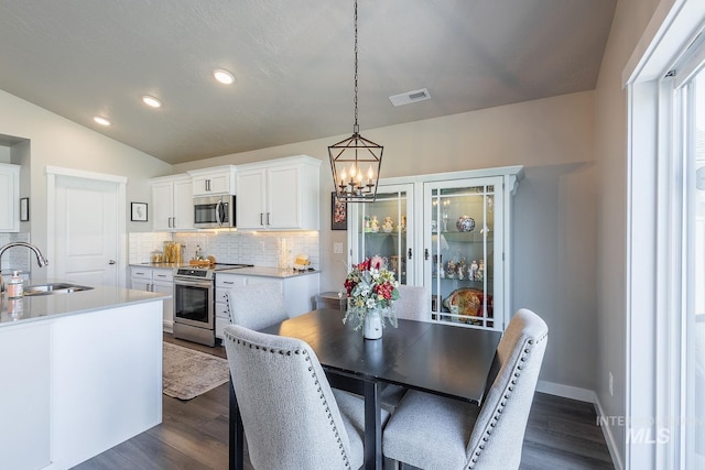 3772 S Walnut Ridge Way, Nampa, ID 83686 - dining area featuring dark wood-style flooring, a chandelier, recessed lighting, and lofted ceiling