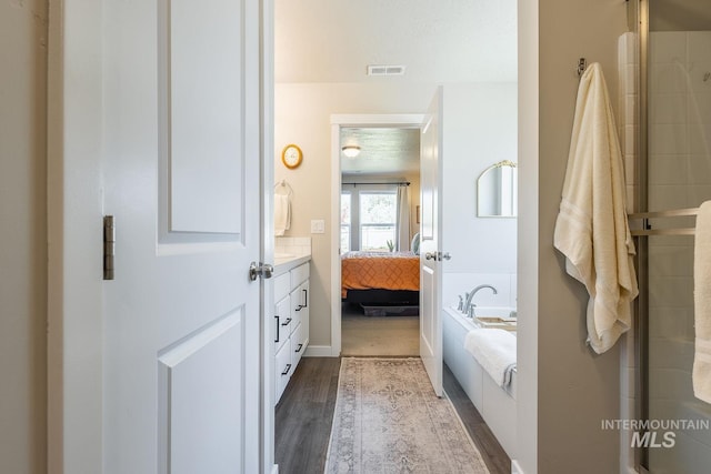 3772 S Walnut Ridge Way, Nampa, ID 83686 - ensuite bathroom with a garden tub, wood finished floors, and vanity