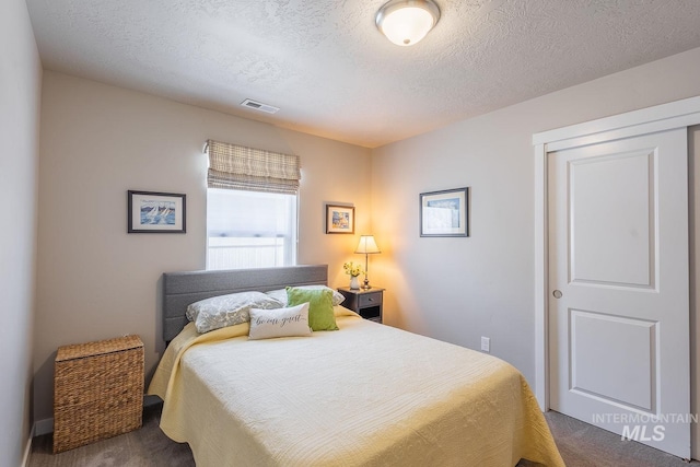 3772 S Walnut Ridge Way, Nampa, ID 83686 - bedroom featuring dark colored carpet and a textured ceiling