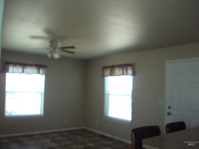 908 Pine St, Lewiston, ID 83501 - unfurnished dining area with a ceiling fan and baseboards