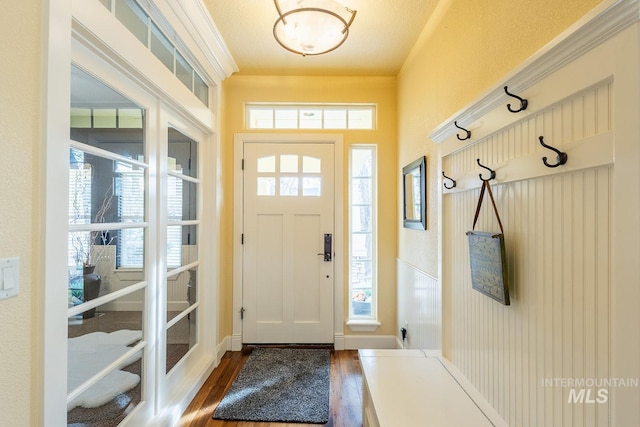 entryway with a textured ceiling and dark hardwood / wood-style floors