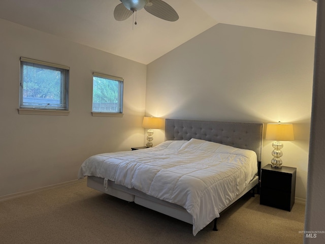 carpeted bedroom featuring baseboards, ceiling fan, and vaulted ceiling