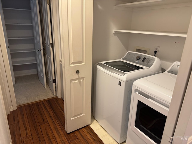 laundry room featuring dark wood-style floors, laundry area, and washing machine and dryer