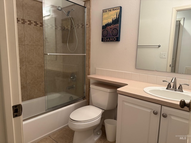 full bath featuring tile patterned flooring, vanity, toilet, and enclosed tub / shower combo