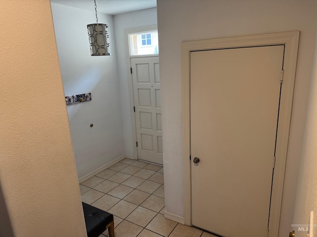 foyer with light tile patterned floors and baseboards