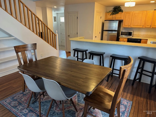 dining area with stairs, dark wood-type flooring, and recessed lighting