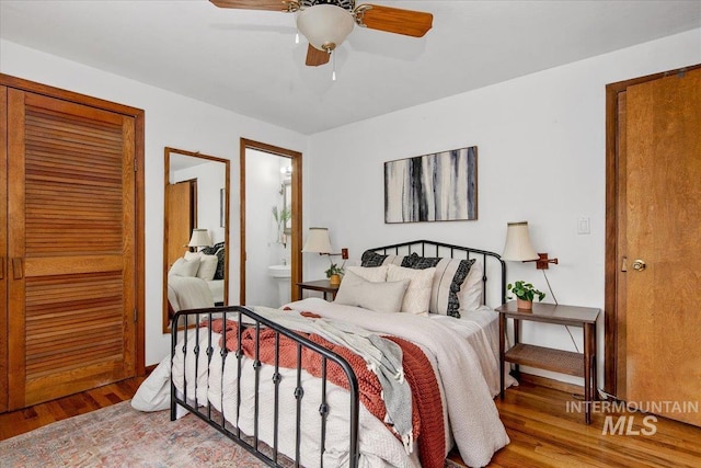 bedroom featuring ensuite bathroom, ceiling fan, and wood finished floors