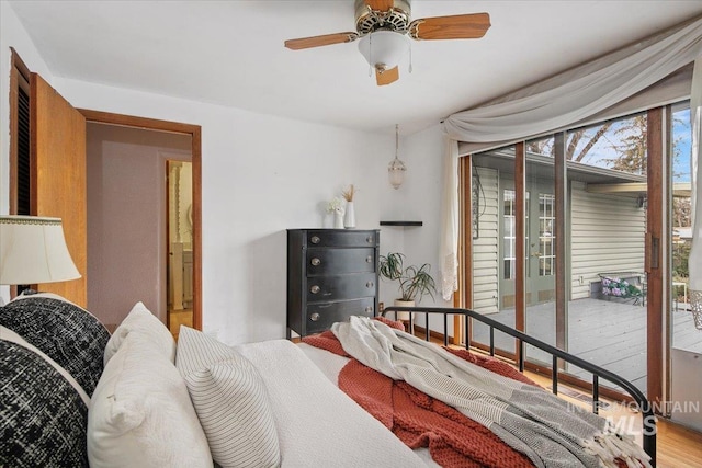 bedroom featuring wood finished floors and access to outside