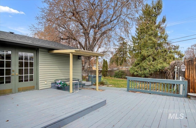 wooden deck featuring french doors and fence