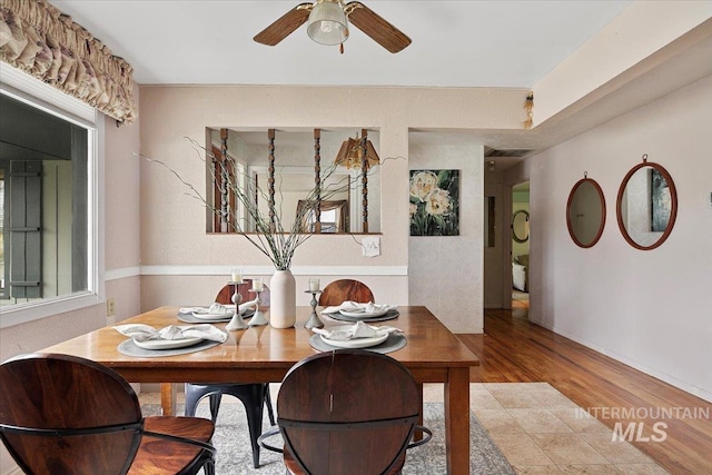 dining area with visible vents, wood finished floors, and ceiling fan