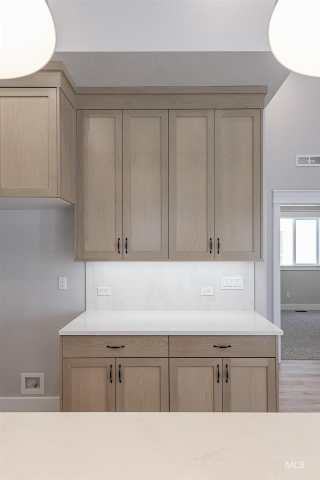 kitchen featuring light countertops, visible vents, and light brown cabinets