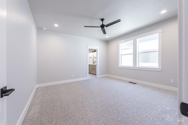 unfurnished room with recessed lighting, carpet, visible vents, and baseboards