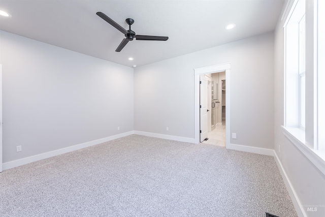 spare room featuring light carpet, baseboards, and recessed lighting