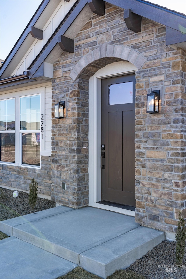 doorway to property featuring stone siding