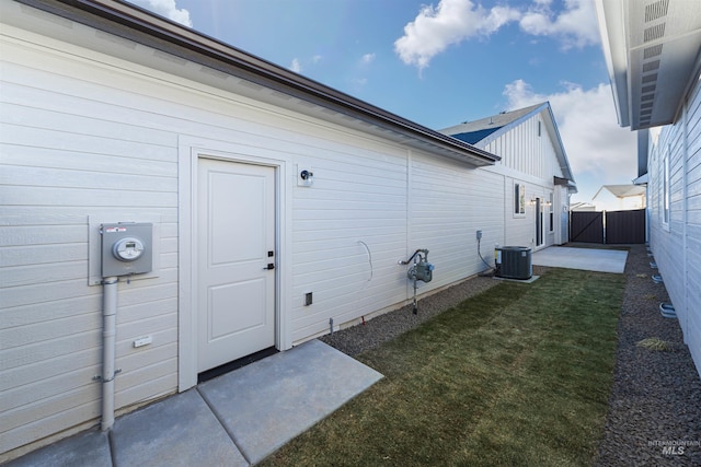 exterior space featuring a lawn, fence, and central air condition unit