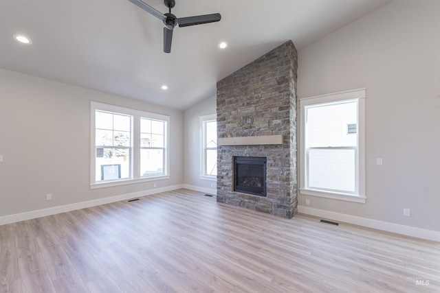 unfurnished living room featuring visible vents, a fireplace, light wood-style flooring, and baseboards