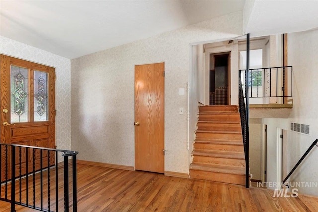 10809 W Cruser, Boise, ID 83709 - entryway with wood finished floors, baseboards, plenty of natural light, wallpapered walls, and stairs
