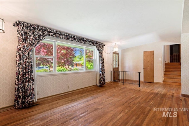 10809 W Cruser, Boise, ID 83709 - unfurnished room with hardwood / wood-style floors and wallpapered walls
