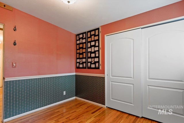 10809 W Cruser, Boise, ID 83709 - unfurnished room with wood finished floors and a wainscoted wall