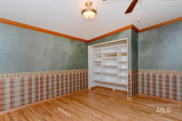 10809 W Cruser, Boise, ID 83709 - empty room with wallpapered walls, wood finished floors, crown molding, a ceiling fan, and wainscoting