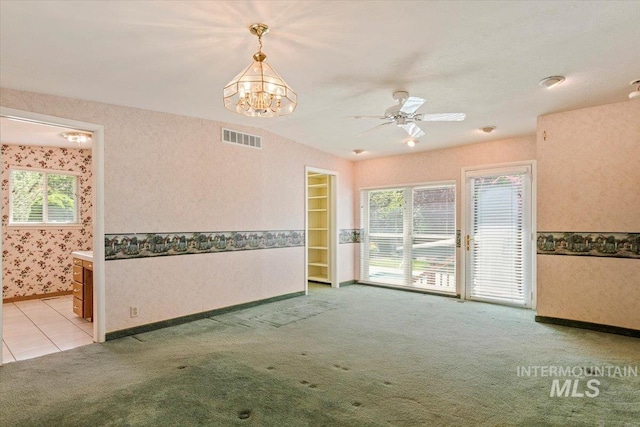 10809 W Cruser, Boise, ID 83709 - empty room featuring light carpet, baseboards, a chandelier, and wallpapered walls