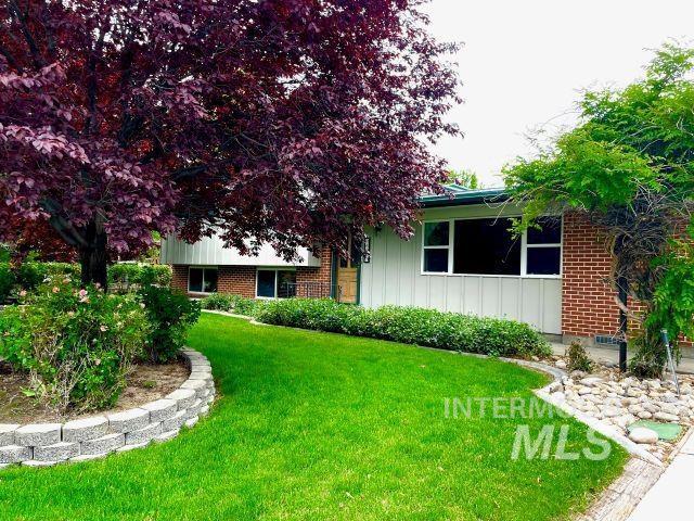 10809 W Cruser, Boise, ID 83709 - view of front of home featuring brick siding, a front yard, and board and batten siding