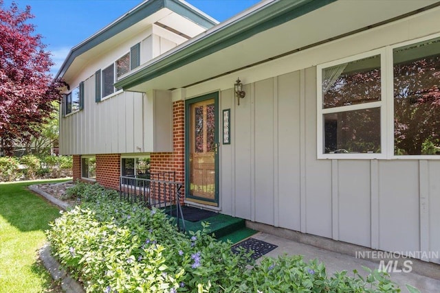 10809 W Cruser, Boise, ID 83709 - view of exterior entry featuring board and batten siding, a porch, and brick siding