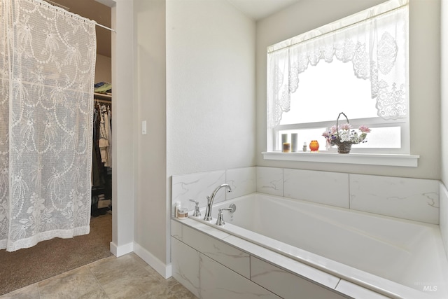 bathroom featuring a relaxing tiled tub