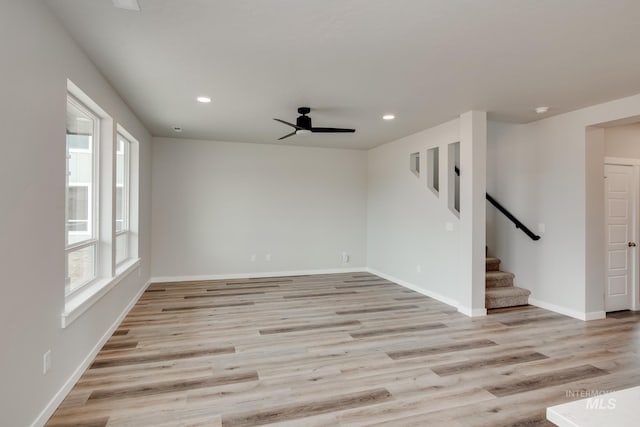 empty room featuring light hardwood / wood-style flooring, ceiling fan, and a healthy amount of sunlight