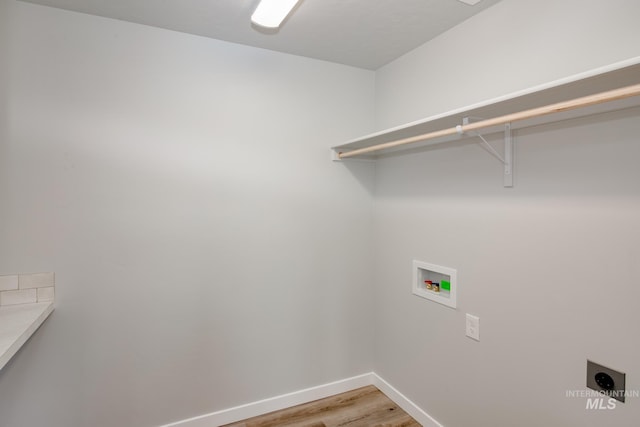 washroom featuring hookup for a washing machine, electric dryer hookup, and wood-type flooring