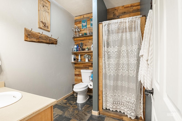 bathroom featuring vanity, toilet, and curtained shower