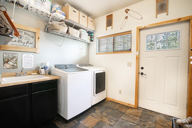 laundry room with washing machine and dryer, sink, and cabinets