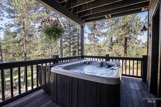 wooden deck with a hot tub