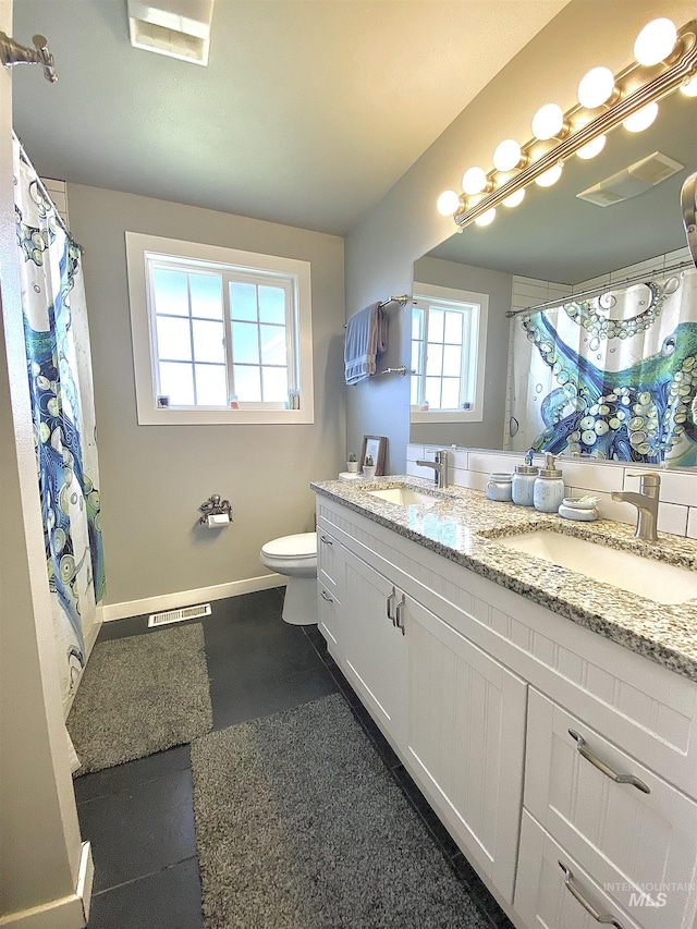 full bath with toilet, baseboards, double vanity, and a shower with shower curtain