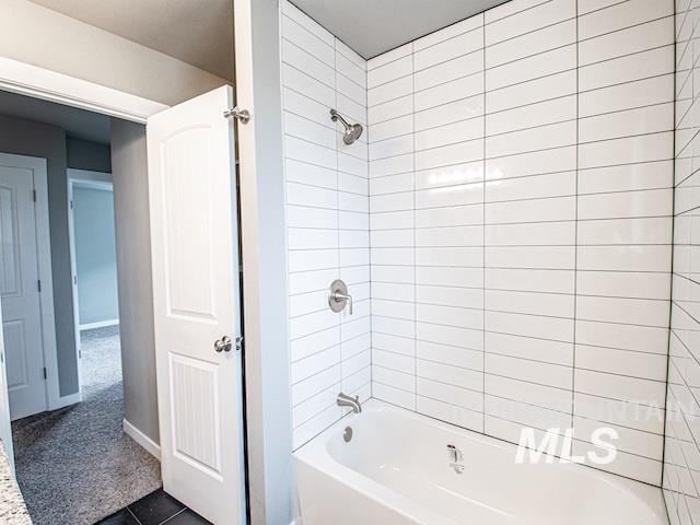 full bath featuring tub / shower combination and baseboards