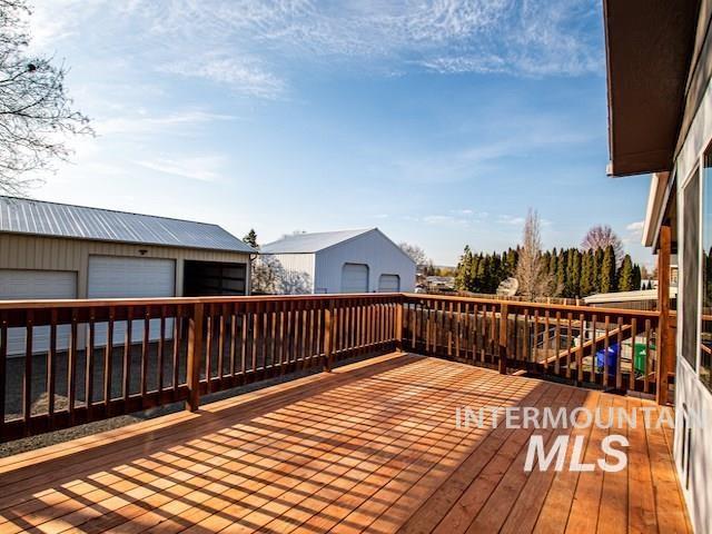 wooden deck featuring an outdoor structure and a detached garage