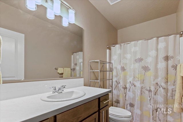 2510 Duchess Trl, Emmett, ID 83617 - bathroom featuring vanity, backsplash, toilet, and curtained shower