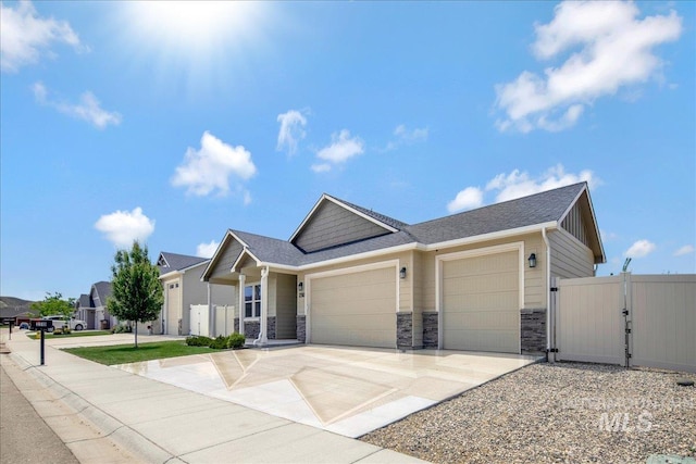 2510 Duchess Trl, Emmett, ID 83617 - view of front of property featuring a garage, a gate, stone siding, driveway, and roof with shingles