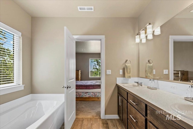 2510 Duchess Trl, Emmett, ID 83617 - full bath featuring wood finished floors, double vanity, ensuite bath, a bath, and baseboards