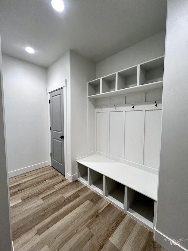mudroom with baseboards, wood finished floors, and recessed lighting