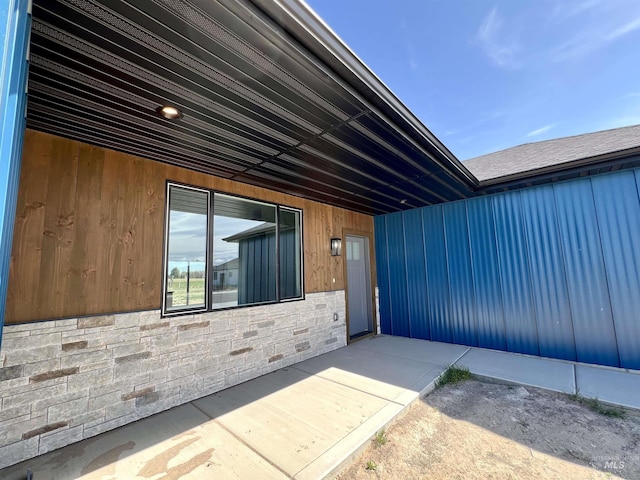 exterior space featuring stone siding