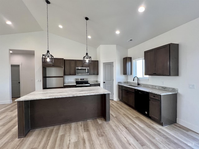 kitchen with lofted ceiling, appliances with stainless steel finishes, dark brown cabinets, and a sink