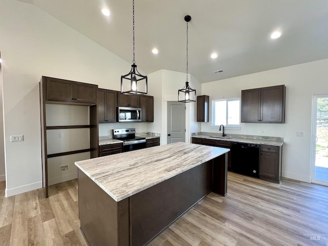 kitchen with a sink, a center island, dark brown cabinetry, light wood-style flooring, and appliances with stainless steel finishes