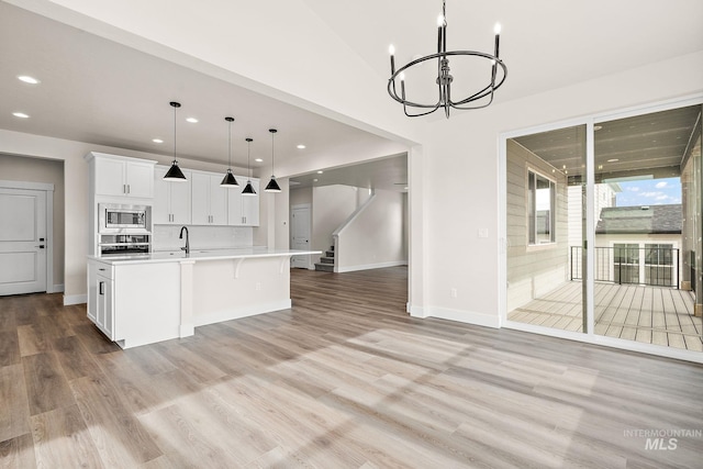 6117 N Torva Ave, Meridian, ID 83646 - kitchen with stainless steel appliances, a chandelier, light countertops, recessed lighting, and white cabinetry