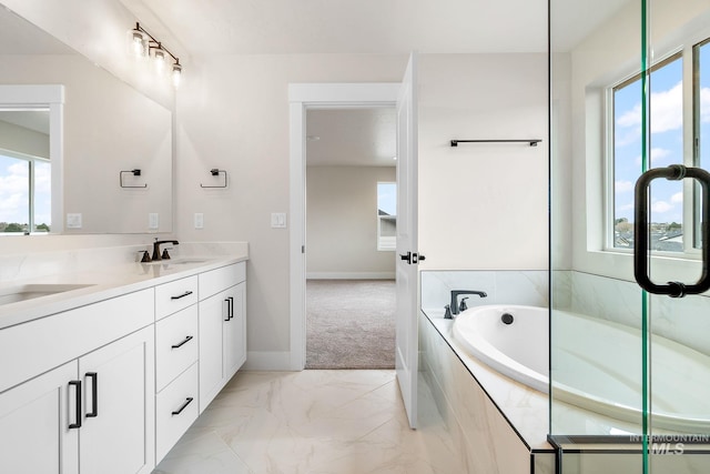 6117 N Torva Ave, Meridian, ID 83646 - full bath with double vanity, a garden tub, marble finish floors, and baseboards