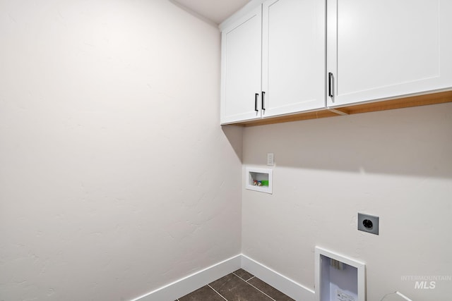 6117 N Torva Ave, Meridian, ID 83646 - laundry area with cabinet space, hookup for an electric dryer, baseboards, hookup for a washing machine, and dark tile patterned flooring