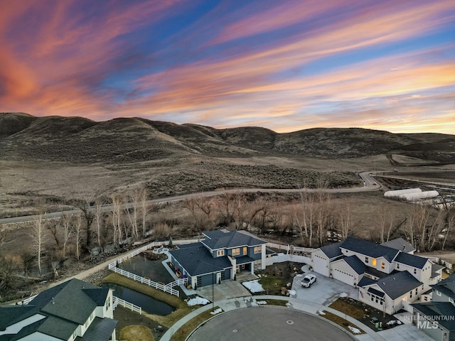 aerial view at dusk with a residential view and a mountain view