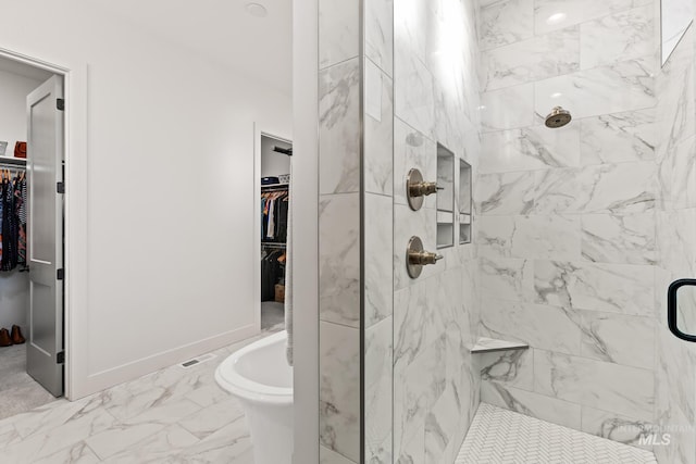 full bath featuring marble finish floor, a shower stall, and baseboards