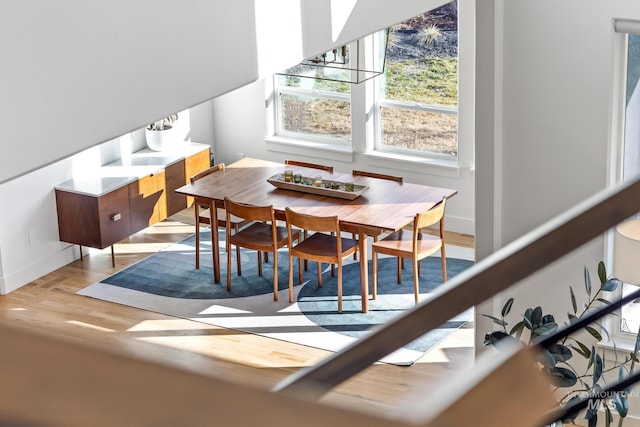 dining area featuring light wood-style floors and baseboards